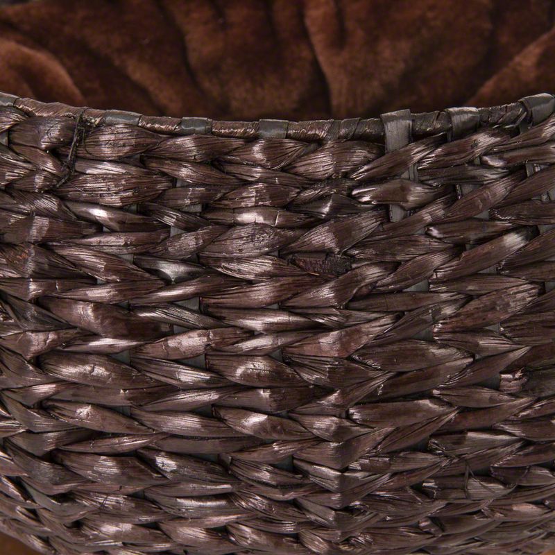 Close-up of a brown basket made of woven natural material with soft brown inner lining.