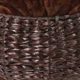 Close-up of a brown basket made of woven natural material with soft brown inner lining.
