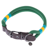 Green fabric dog collar with yellow-blue accents, brown leather clasp and metal ring. Tag with NT logo visible.