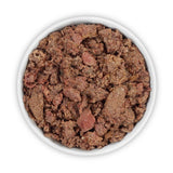 Close-up of wet food in a white bowl, consisting of brown and red meat pieces.