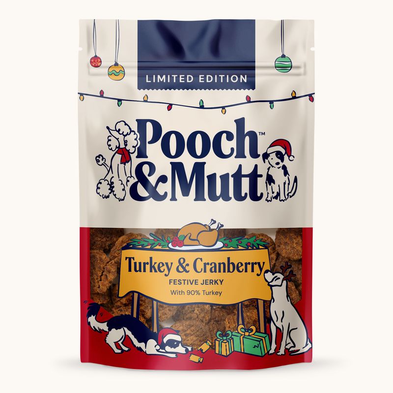Pooch & Mutt Limited Edition Turkey & Cranberry Festive Jerky with 90% turkey. Christmas design with gifts and dogs on the packaging.