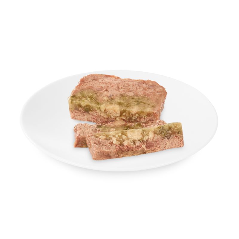 Close-up of two slices of wet food with visible green and beige layers on a white plate.