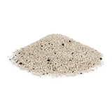 Pile of fine, light grey granules with occasional dark particles, possibly cat litter.
