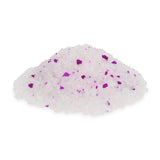Pile of white crystals with occasional violet particles, possibly decorative or functional granules.