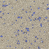 Close-up of cat litter with grey granules and blue particles.