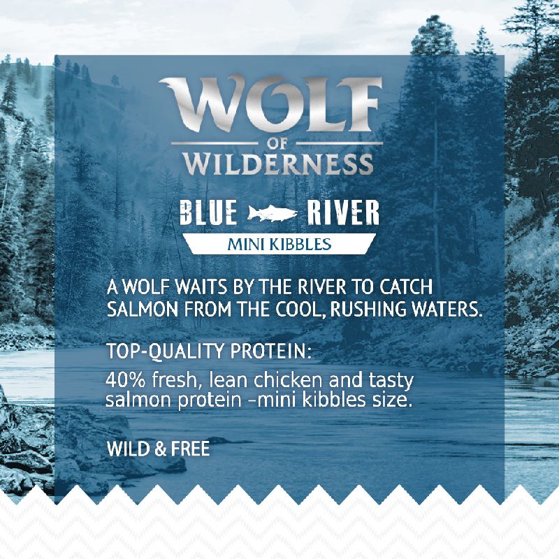 Wolf of Wilderness Blue River Mini Kibbles. Contains 40% fresh, lean chicken and salmon protein in mini kibbles size. Wild & Free. A wolf waits by the river to catch salmon.